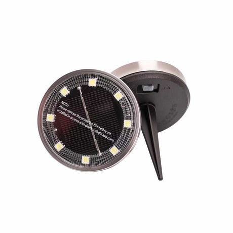 Solar garden spike light with warm white LEDs in a lawn