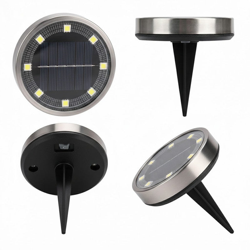 Solar garden spike light with warm white LEDs in a lawn