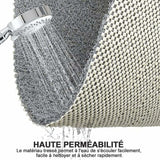 Close up of the looped loofah textured surface and open drainage holes on the PVC shower mat