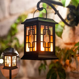 Solar garden torch light with dancing flame effect staked in a lawn
