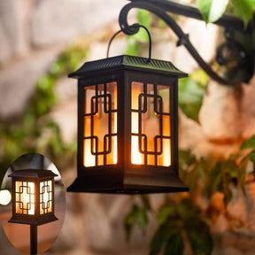 Solar garden torch light with dancing flame effect staked in a lawn