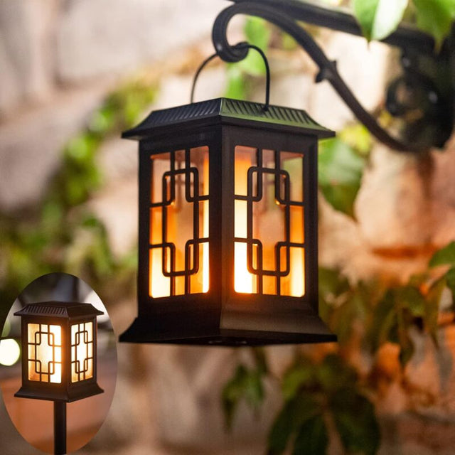 Solar garden torch light with dancing flame effect staked in a lawn