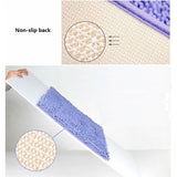 Shaggy chenille bath mat shown beside a basin, with its non slip base on tiled flooring