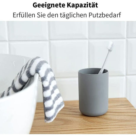 Close up of the smooth rim and grey finish of the plastic toothbrush cup