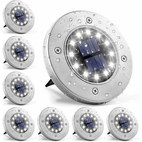 Stainless steel solar ground light with white LEDs in a garden
