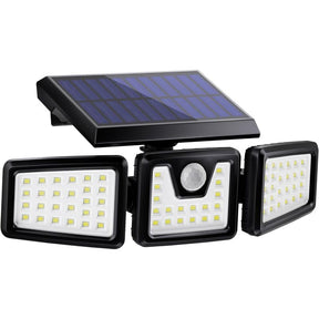 Three head solar spotlight with motion sensor lighting a garden facade