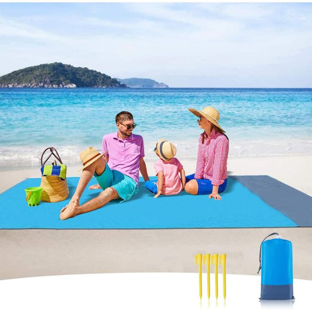 Troutbeck blue and grey beach blanket 210 x 200cm anchored on sand with corner stakes and breathable water resistant polyester top