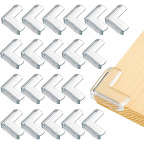Set of clear self adhesive corner guards protecting sharp furniture edges
