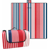 Coniston striped microfleece picnic blanket 200 x 200cm laid on grass with red blue and white stripe top and water resistant backing