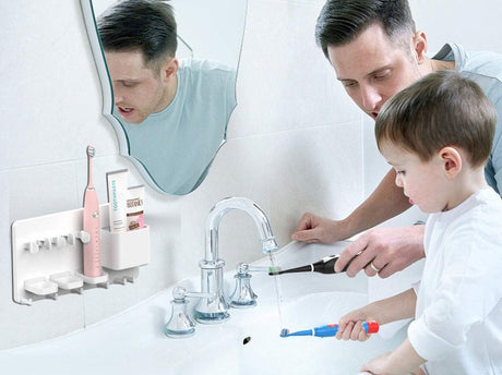 White organiser installed above a bathroom basin holding brushes and towels