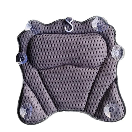 Grey bath pillow hanging by its built in hook to dry after use