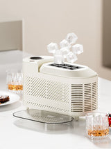 Compact purple ice maker on benchtop beside chilled drinks