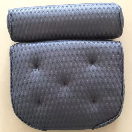 Blue bath pillow suctioned to a smooth bathtub surface