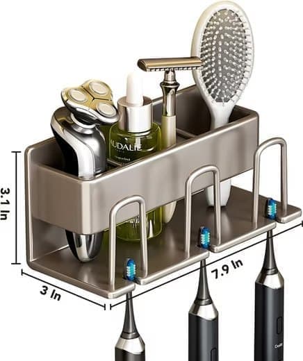Wall mounted light grey rack holding three toothbrushes with the cup below