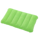 Green inflatable camping pillow set up in a tent