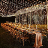 Warm white LED curtain fairy lights cascading down a wall backdrop