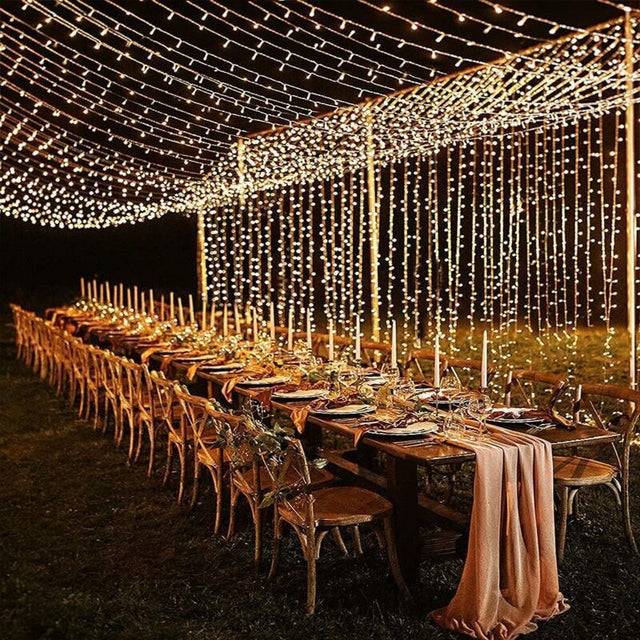 Warm white LED curtain fairy lights cascading down a wall backdrop