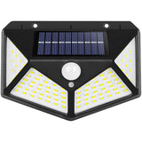 Four sided 100 LED solar motion sensor light mounted on a garden wall