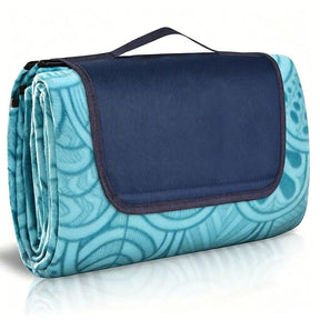 Patterdale peacock blue plaid picnic blanket 200 x 150cm laid on grass with soft insulated top and water resistant sand proof base