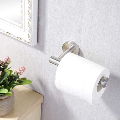 Toilet roll holder mounted on a tiled bathroom wall holding a roll