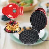 Freshly cooked waffle in the compact 420 W red waffle maker