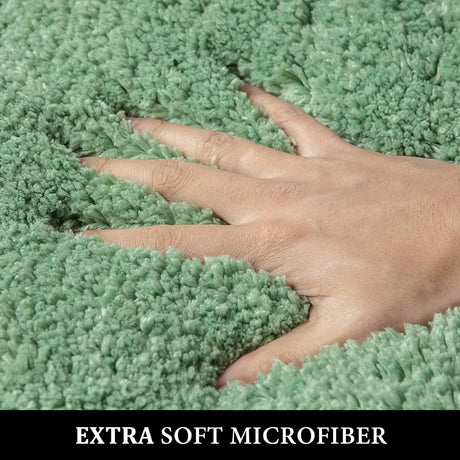 Large sage green microfibre bath mat, 51 x 76 cm, in front of a shower