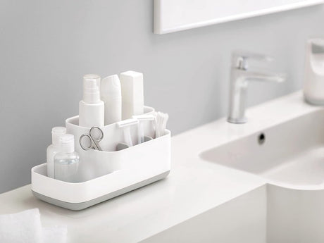 Sorting compartments of the white organiser holding brushes and razors