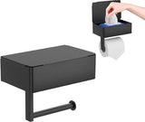 Black stainless steel toilet roll holder with a flat shelf above the roll