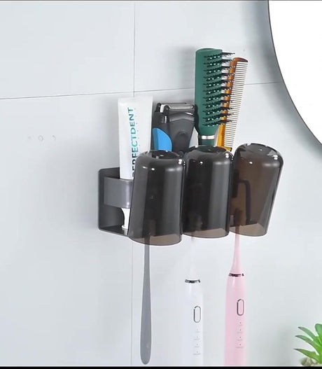 Metal toothbrush holder holding brushes, toothpaste and a razor