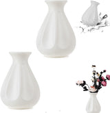 Matching pair of white faux ceramic vases styled together