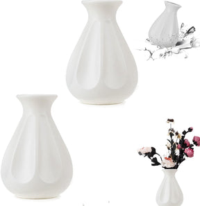 Matching pair of white faux ceramic vases styled together