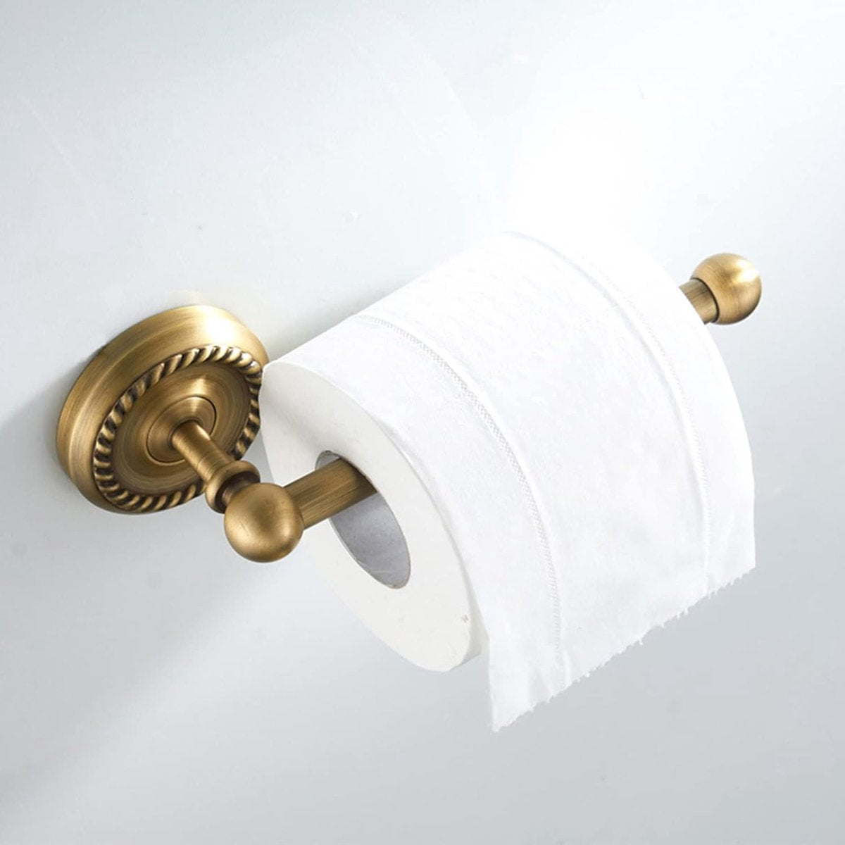 Close up of the antique brass finish and smooth surface of the toilet roll holder