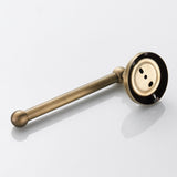 Antique brass toilet roll holder holding an extra large paper roll