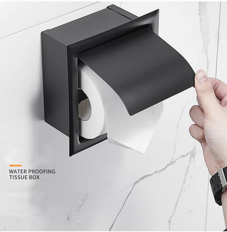 Concealed toilet roll holder wall mounted beside a toilet with the cover closed