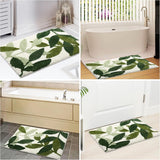 Green leaf print bath mat laid on a tiled bathroom floor