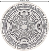 Detail of knotted fringe trim on grey round rug