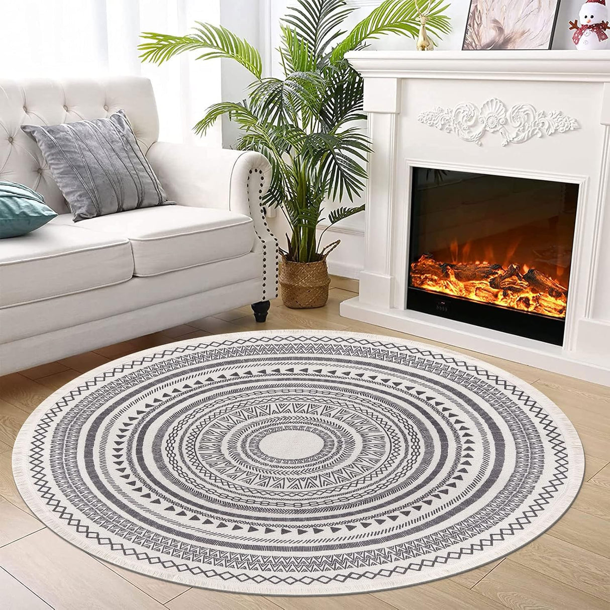 Grey fringed round rug styled on a floor