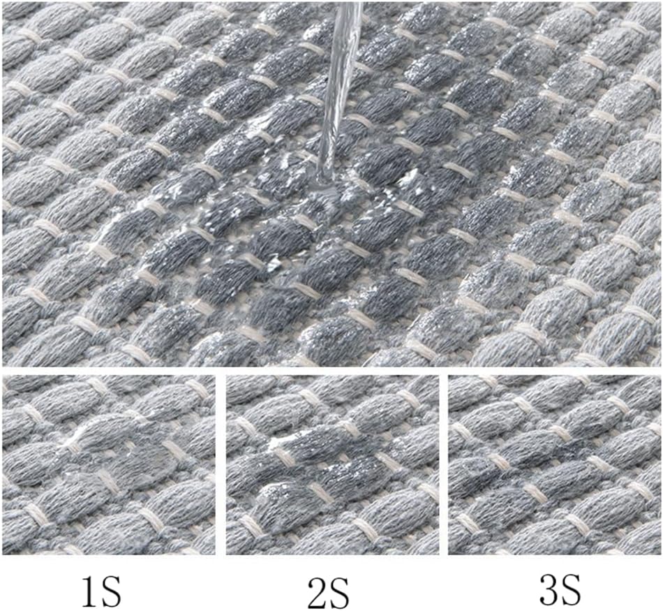 Tassel detail along the end of the beige braided bath mat