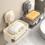 Suction cup soap dish mounted on a tiled wall holding a soap bar