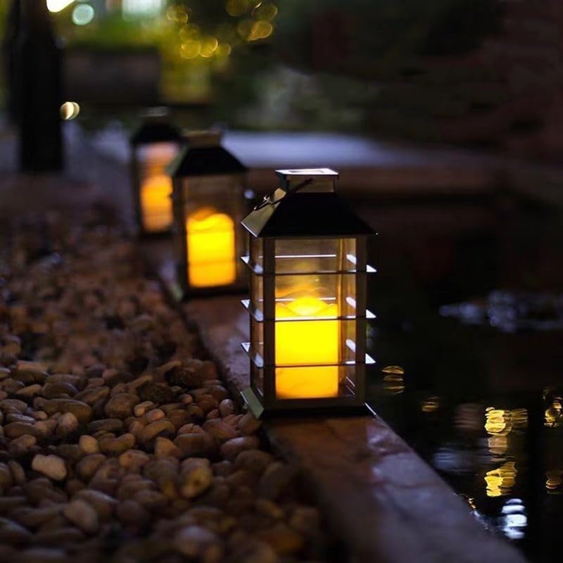 Two solar candle lamps with flickering flame effect hung in a garden