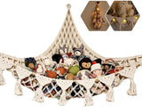 Beige stuffed animal storage hammock net mounted in a room corner