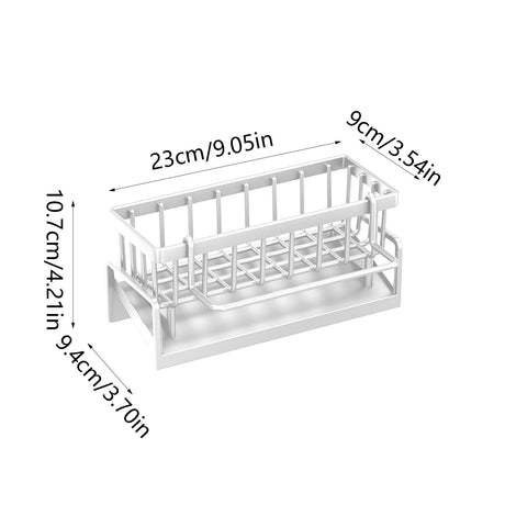 White sink caddy holding sponges, a brush and soap beside a kitchen tap