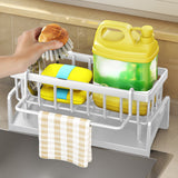 Dishcloth hanging from the towel rod on the white sink caddy