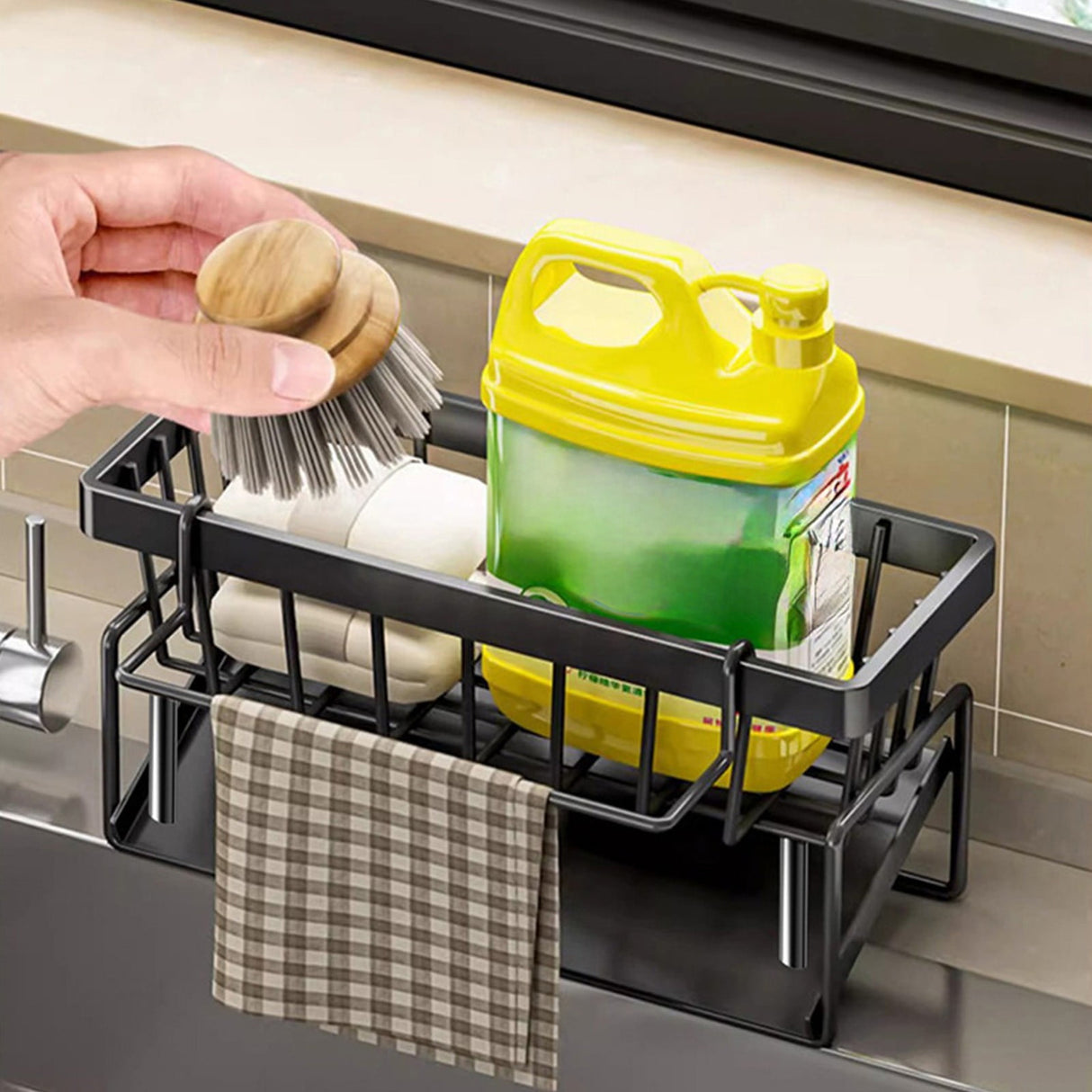 Dishcloth hanging from the towel rod of the black sink caddy