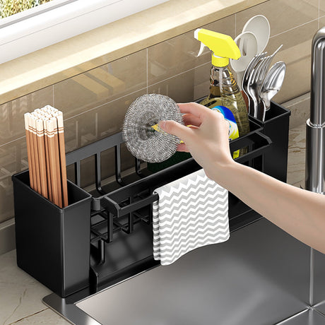 Dishcloth hanging from the towel rod of the black sink caddy