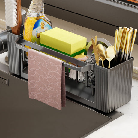 Dishcloth hanging from the towel rod of the grey sink caddy