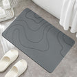 Dark grey quick drying absorbent bath mat, 41 x 61 cm, on a bathroom floor