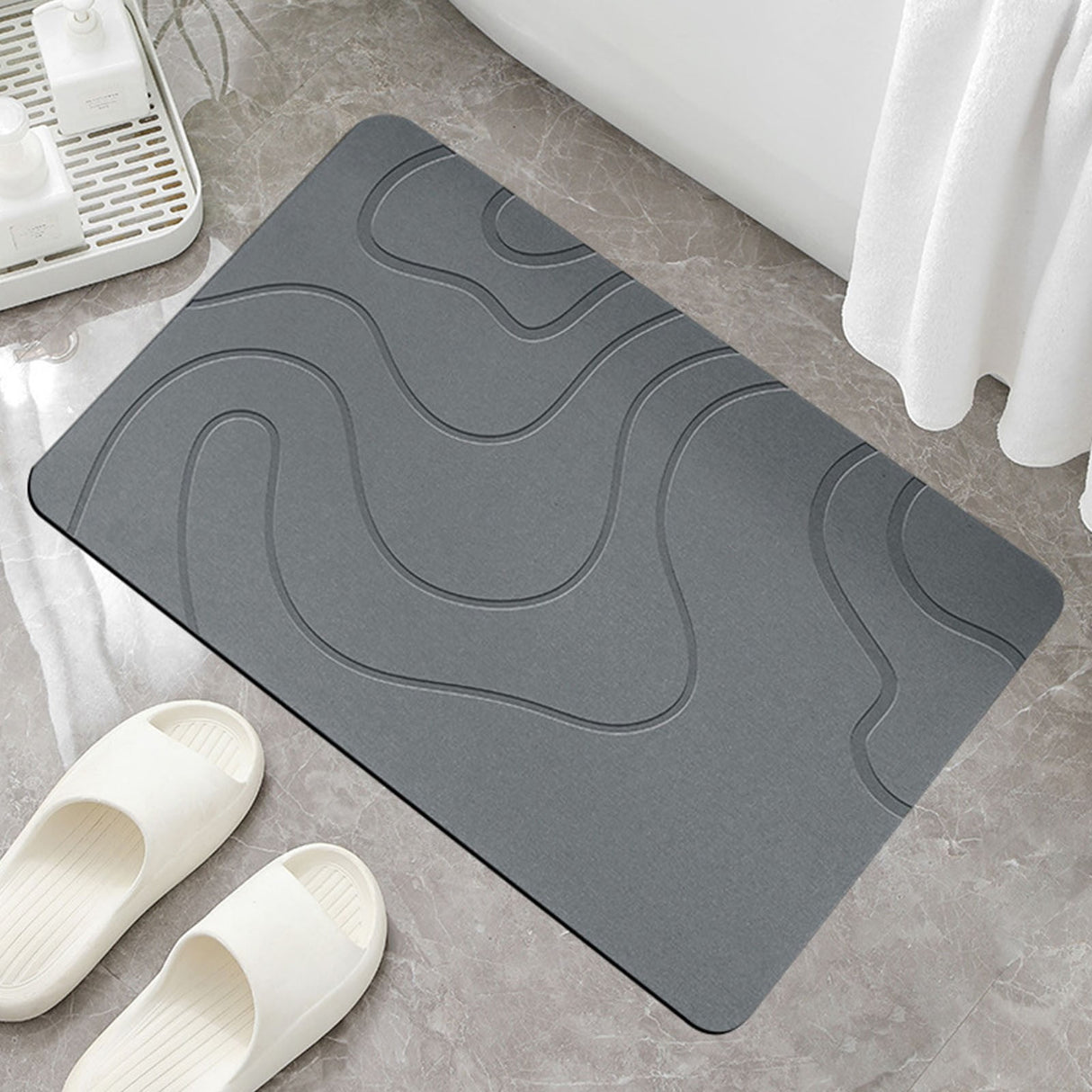 Dark grey quick drying absorbent bath mat, 41 x 61 cm, on a bathroom floor