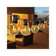 Warm white G40 globe string lights hung above an outdoor patio table