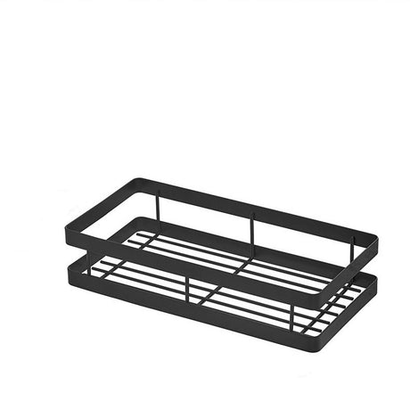 Slim black metal shelf fixed to a tiled wall holding small bottles and jars